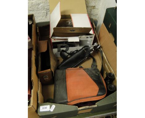 A Canon camera with folding tripod, binoculars, etc.