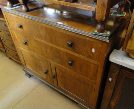 A walnut cabinet with drawer and cupboards, bracket feet.