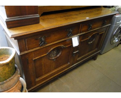 A stylised oak Art Nouveau dresser base with 2 frieze drawers and panelled cupboards under, width 5'.