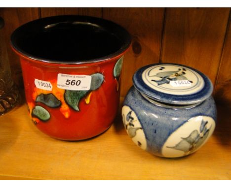 A blue and white jar and cover and a Poole Pottery jardiniere with painted designs.