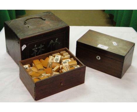 A rosewood tea caddy with fitted interior and a Mah Jong set.