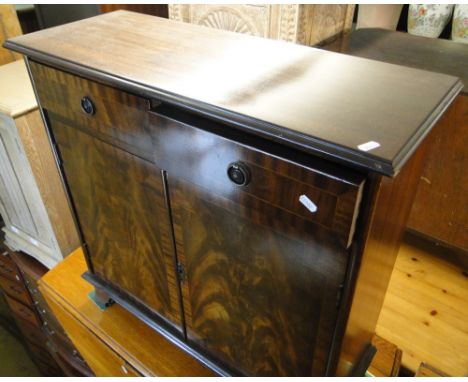 A reproduction mahogany cabinet with drawers and cupboards under, bracket feet.