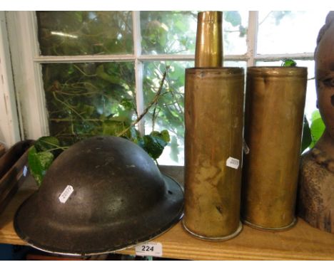 3 Brass shell cases and a army helmet.