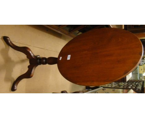 A Victorian mahogany tilt top table with tripod base.