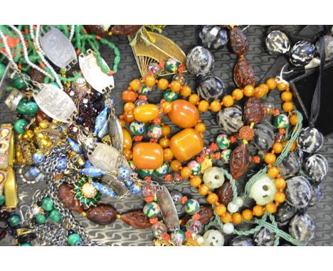 A collection of necklaces and costume jewellery, including malachite, coquilla nut, jade and coral. CONDITION REPORT: Good co