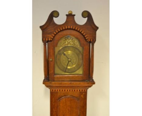 A late 19th/early 20th century small oak longcase clock in 17th century style, arched brass dial with central alarm disk, str