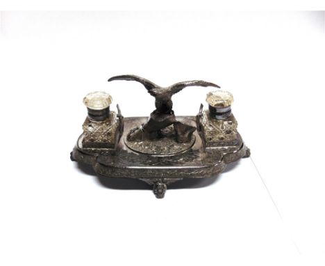 A LATE VICTORIAN ELECTROPLATED STANDISH  to the centre is a spread winged eagle on a rocky outcrop, flanked by glass wells, p