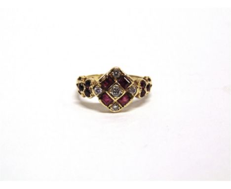 AN 18 CARAT GOLD DIAMOND AND RUBY RING the central diamond enclosed by four square cut rubies and diamonds at the compass poi