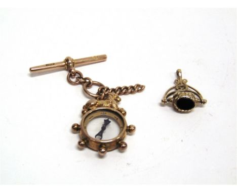 A LATE VICTORIAN 9 CARAT GOLD COMPASS WATCH FOB with a lion surmount, with a T bar and short section of chain attached; with 