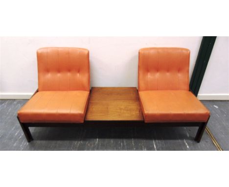 A TWO SEATER RECEPTION SOFA/TABLE  with pair of orange vinyl chairs flanking teak table, the chairs labelled 'EVEREST your we