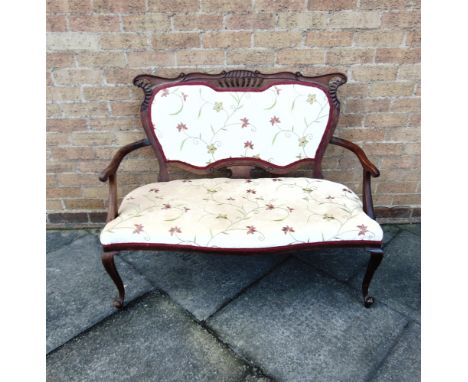 AN EDWARDIAN RE-UPHOLSTERED TWO SEATER SALON SOFA  on carved cabriole supports, 150cm wide