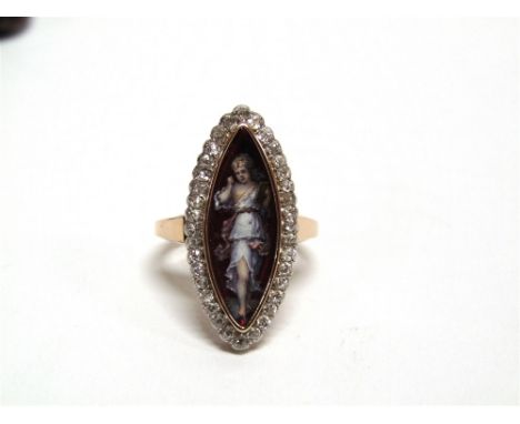 A LIMOGES ENAMEL AND DIAMOND RING  the navette image of a girl with a book, enclosed by thirty six small old cut stones total