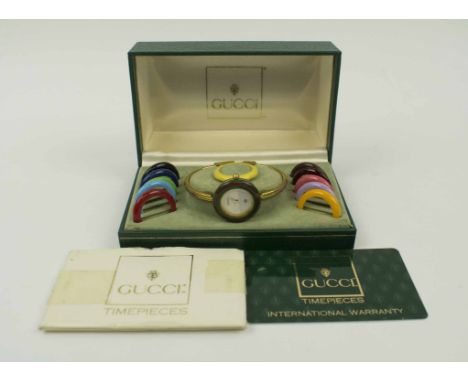 VINTAGE GUCCI WRIST WATCH, with eleven various coloured bezels (twelve in total), in working condition, boxed with documentat