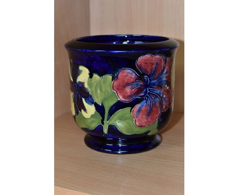 A MOORCROFT POTTERY PLANTER, in the Hibiscus pattern on a dark blue ground, height 13cm x internal diameter 10.5cm, impressed