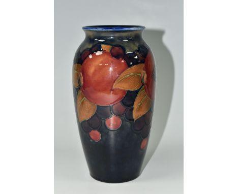 A MOORCROFT POTTERY 'POMEGRANATE' PATTERN VASE, of ovoid form, tube lined with pomegranates, berries and foliage on a blue gr
