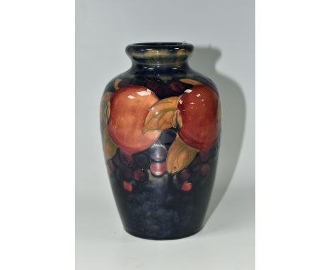 A MOORCROFT POTTERY 'POMEGRANATE' PATTERN VASE, of ovoid form, tube lined with pomegranates, berries and foliage on a blue gr
