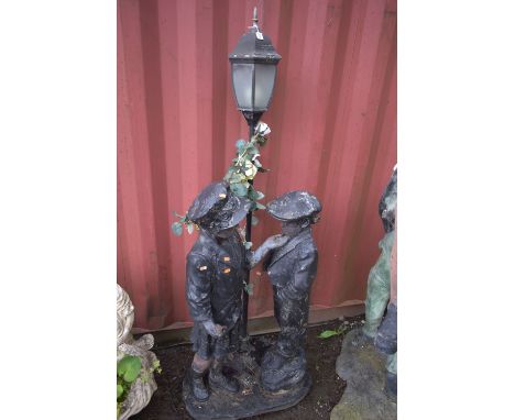 A FIGURAL GARDEN LANTERN, that's behind a boy and girl, height 178cm (condition report: finish peeling, lantern untested)