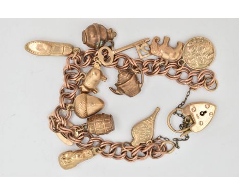 A 9CT GOLD CHARM BRACELET, double curb link bracelet, some links stamped 9.375, fitted with a heart padlock clasp, hallmarked