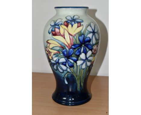 A MOORCROFT POTTERY 'SPRING FLOWERS' PATTERN VASE, of baluster form, tube lined with colourful spring flowers on a graduated 