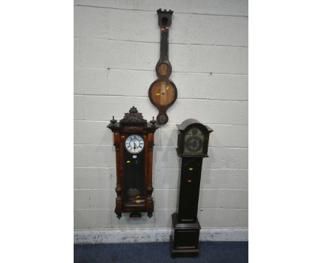 A LATE 19TH CENTURY WALNUT WALL CLOCK, with a foliate crest, flanked by twin finials, the arched door enclosing a seven inch 