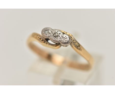 A YELLOW METAL DIAMOND RING, three single cut diamonds, illusion set in a white metal mount, cross over yellow metal shoulder