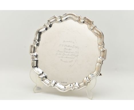 AN ELIZABETH II SILVER PRESENTATION SALVER, of a circular form with wavy edge, engraving to the centre reads 'Presented to C.