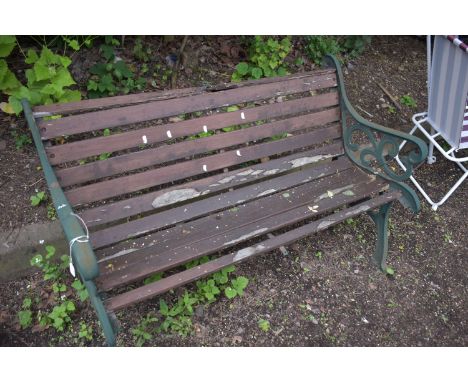 A CAST IRON GARDEN BENCH, with real slats (condition report: rickety and in need of attention)