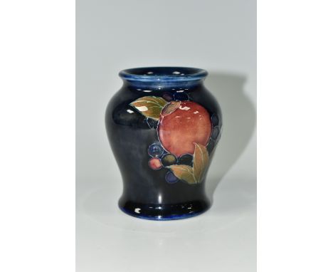 A MOORCROFT POTTERY 'POMEGRANATE' PATTERN VASE, of small baluster form, tube lined with pomegranates, berries and foliage on 