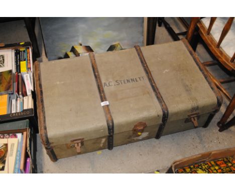 A metal bound and canvas travelling trunk 