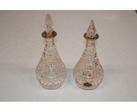 Two cut glass silver necked decanters 