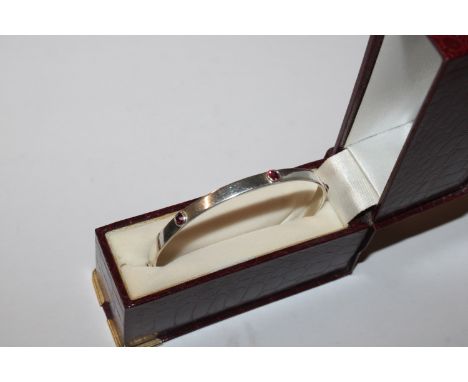 A Hallmarked solid Sterling silver and pink padparadscha sapphire bangle 