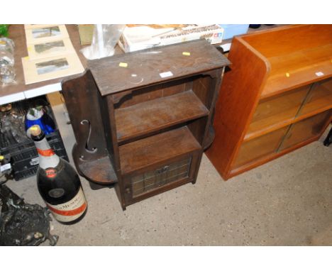 An oak open fronted bookcase raised on cupboard base with stained glass panel 