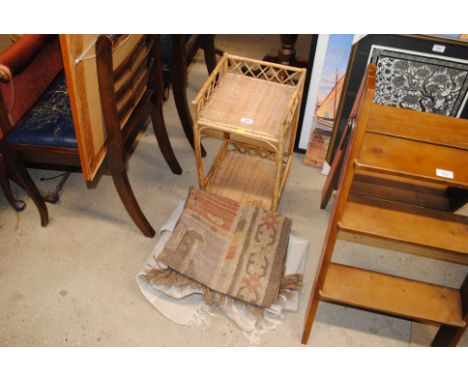 A cane two tier shelf and two rugs 