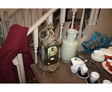 An American Ansonia gilt metal four glass mantel clock with cherub decoration