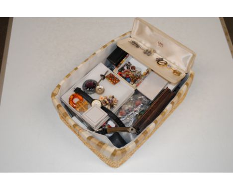 A basket containing a large quantity of costume jewellery to include various wrist watches, ear-rings, a Sterling silver broo