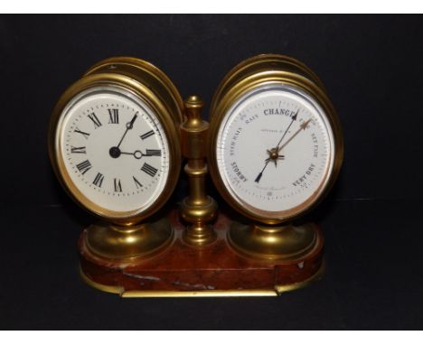 A twin dial brass clock/barometer on red marble base, 6.25" across.