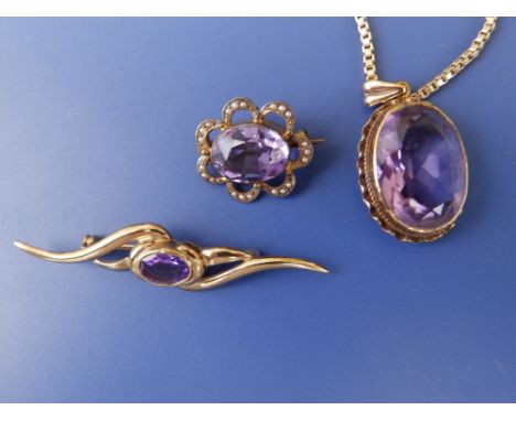 An oval amethyst pendant on 9c box link necklace chain and two amethyst brooches. (3)