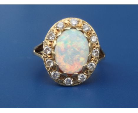 An opal &amp; diamond oval cluster ring on 18ct shank.  Finger size K/L.