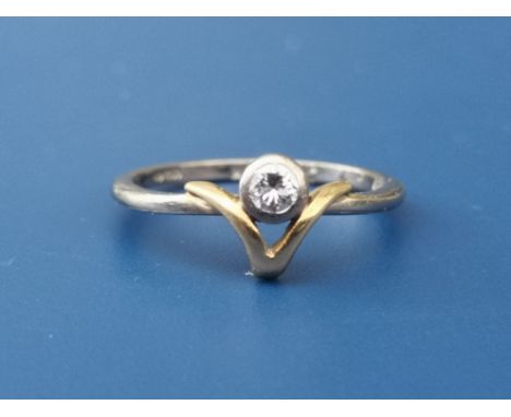 A small diamond collet set 18ct gold solitaire ring in wishbone setting.  Finger size K.