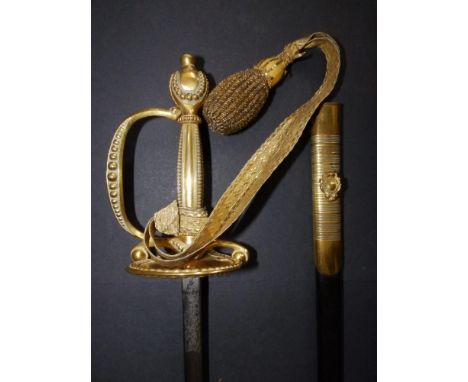 An Edwardian court sword with gilt hilt and decorated blade in (repaired) leather scabbard, the blade 31.5".