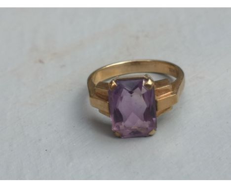 A rectangular cut amethyst solitaire ring on 9ct yellow shank.  Finger size L.