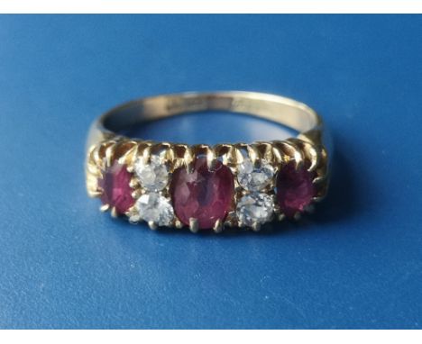 An Edwardian seven stone ruby &amp; diamond set gold ring.  Finger size K.