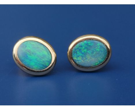 A pair of oval opal panel earrings - 14K, 11mm overall.