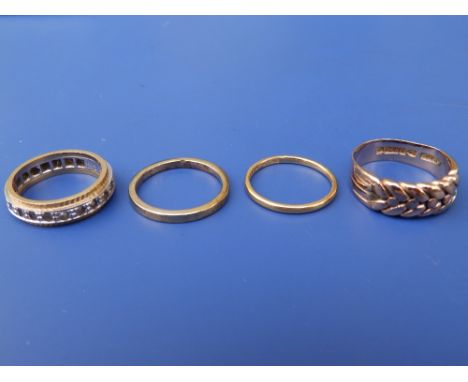 A small 22ct wedding ring, finger size K, an 18ct band and two other rings. (4)