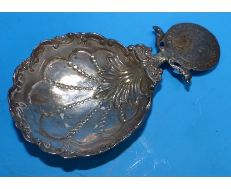 A 19th century continental shell bowl scoop/ladle with handle in the form of a coin, beaded and scroll decoration to the bowl