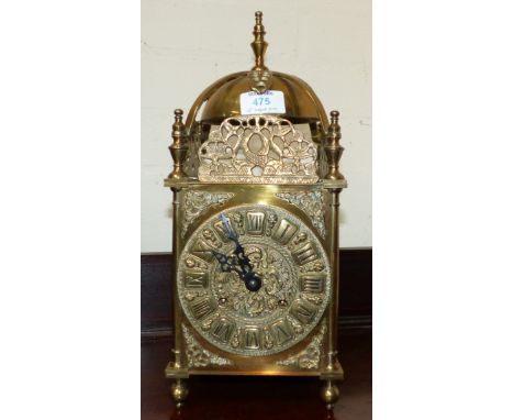 An early/mid-20th century reproduction brass lantern clock with balance spring movement striking on bell