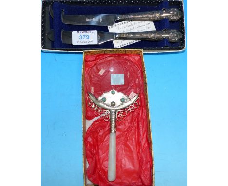 A Chinese magnifying glass with hardstone handle and jade coloured gems; a boxed silver handle butter and cheese knife set