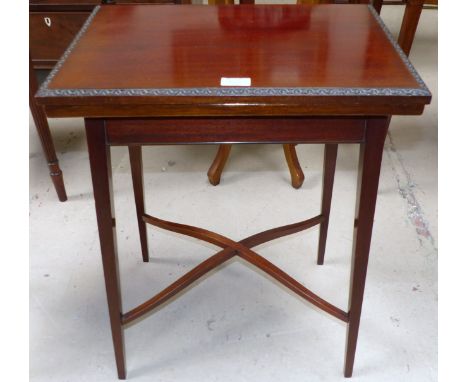 A 1920's mahogany rectangular fold-over card/occasional table on square top legs