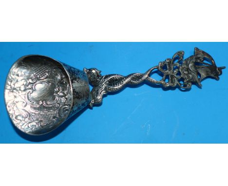 A 19th century continental scoop/ladle with ship terminal and entwined dolphin stem, the bowls embossed with shells and acant