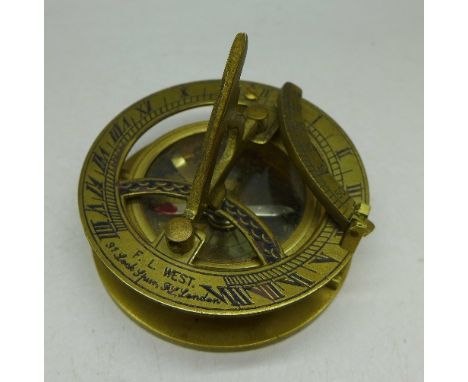 A reproduction brass folding compass/sun dial marked F.L. West, London